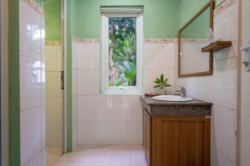 La salle de bains est pourvue d'un lavabo et d'une fenêtre. dans l'établissement Chay Lap Farmstay Phong Nha, à Ðá Lòn