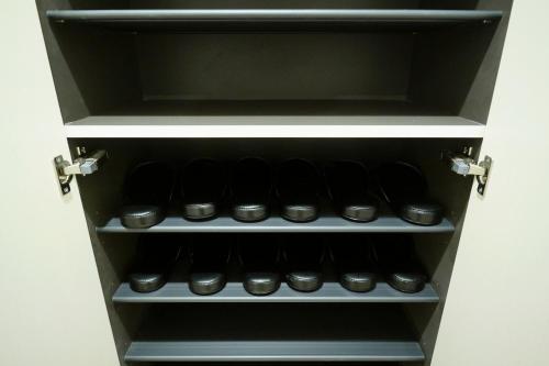 a cupboard filled with lots of black cupcakes at J-ARC Akebonobashi in Tokyo