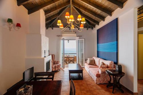a living room with a couch and a table at Apelon Tiritas Villas in Leonidion
