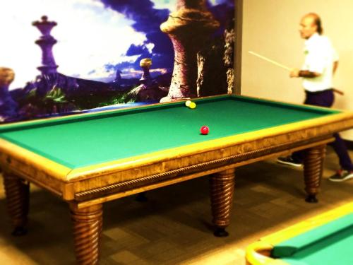 a pool table with a ball on top of it at Svalinn Hotel in Izmir