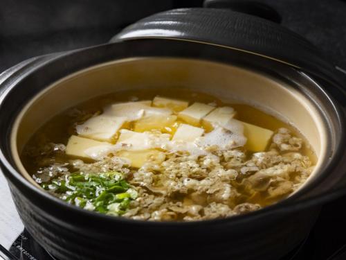 a pot of soup with meat and vegetables in it at Hotel Wing International Select Osaka Umeda in Osaka