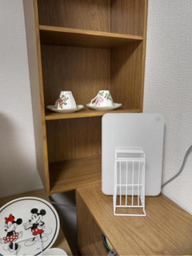 a model of a toy kitchen with a mickey mouse shoes at アサカヤマ　ゲストハウス in Sakai