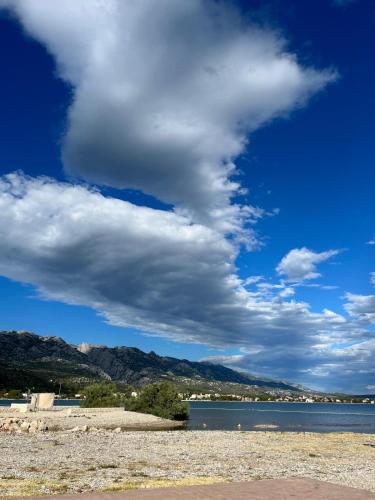 a cloudy sky over a body of water at Apartment Lora in Starigrad-Paklenica