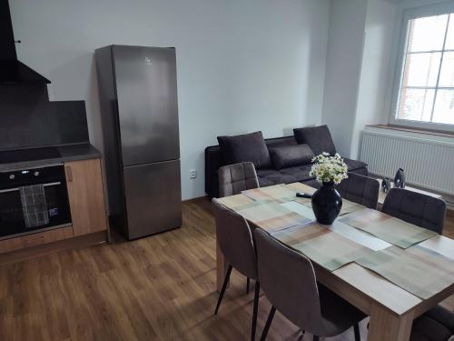 a kitchen and dining room with a table and a couch at Zámeček Čeřov in Jičín