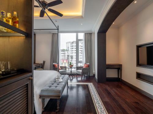 a hotel room with a bed and a couch at De Syloia Hotel in Hanoi