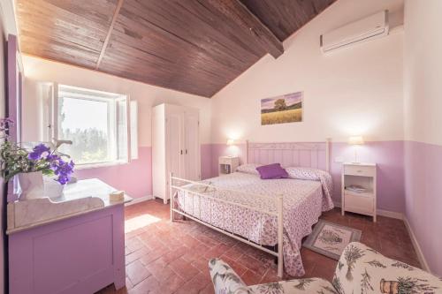 a bedroom with a bed and a dog in a room at Tenuta di Poggio Cavallo in Istia dʼOmbrone