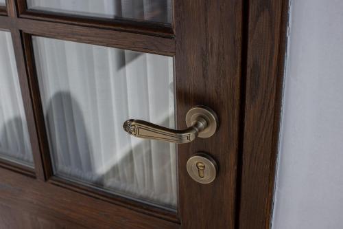 a wooden door with a brass door handle at Vista Boutique Hotel in Berat