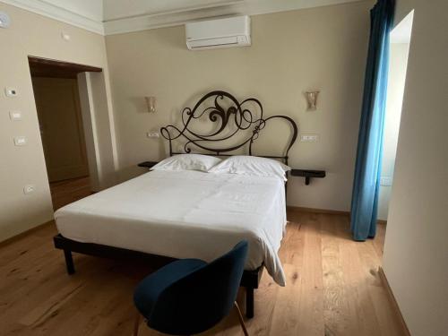 a bedroom with a bed and a chair in it at Dimora Santa Chiara in Ripatransone