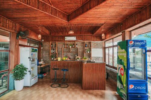 a kitchen with a counter in the middle of a room at Tam Coc Ninh Binh Bungalow in Ninh Binh