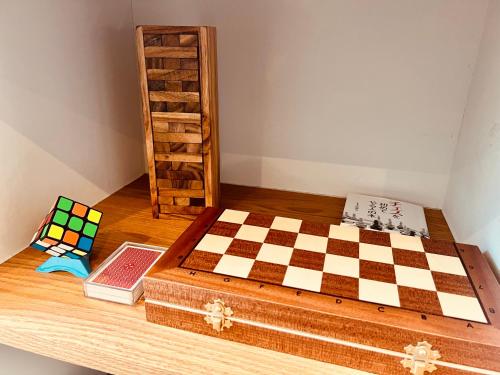 a chess board sitting on top of a wooden table at TRIGON HOUSE HOTEL KOFU in Kofu
