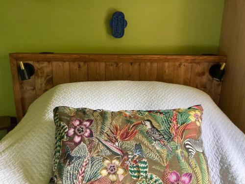 a bed with a wooden headboard with a pillow on it at Casa Bauxells in Sahorre
