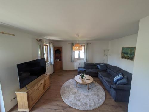 a living room with a couch and a flat screen tv at Ferienwohnung Elisabeth in Bischofswiesen