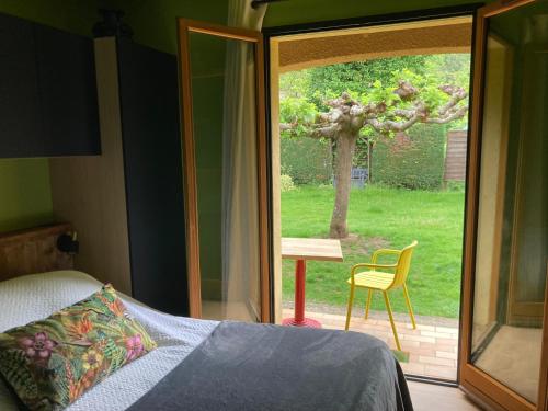 a bedroom with a bed and a sliding glass door at Casa Bauxells in Sahorre