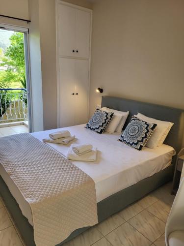 a bedroom with a large bed with towels on it at Mare blu Lefkada in Nydri