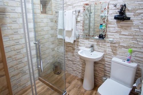 ein Badezimmer mit Dusche, Toilette und Waschbecken in der Unterkunft Haghartsin Hotel and Restaurant in Dilidschan