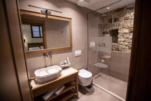 a bathroom with a sink and a toilet and a shower at Vista Boutique Hotel in Berat