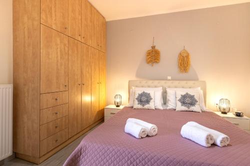 a bedroom with a bed with two pillows on it at FoRest & sea view apartment in Argostoli