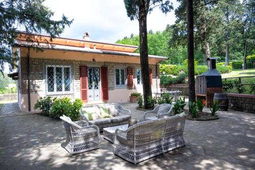 a group of chairs in front of a house at Villa Casa del Mugnaio in Pontassieve