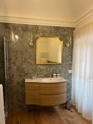a bathroom with a sink and a mirror at Dimora Santa Chiara in Ripatransone