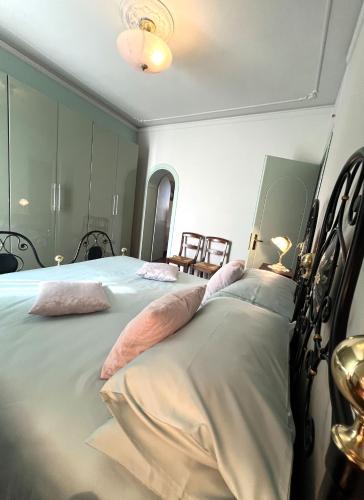 a bedroom with a large bed with pink pillows at La Dimora del Centro in Iesi