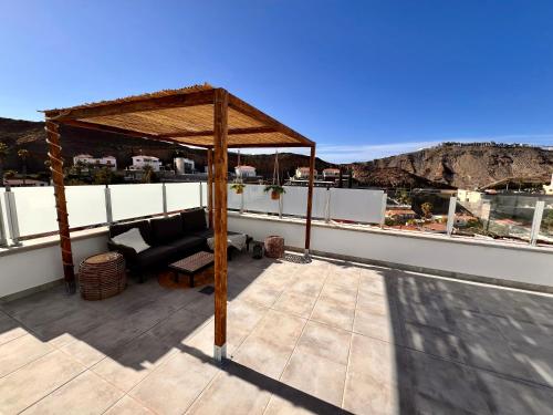 a gazebo on the roof of a house at Escape to paradise luxury Poolvilla with ocieanview near Amadores in Mogán