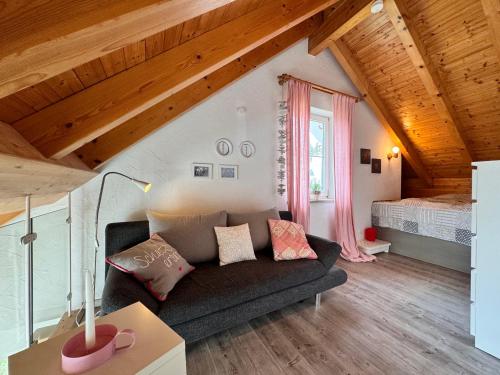 a living room with a couch and a bed at Casa Via Bodman-Ludwigshafen in Bodman-Ludwigshafen