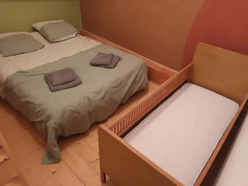 a bed with two pillows on it in a room at Gîte-Nature-Poitou in Archigny
