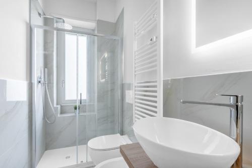 a white bathroom with a toilet and a sink at SIL5 - Apartment Bright - Luxury in Milan