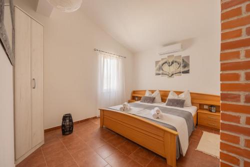 Postel nebo postele na pokoji v ubytování Holiday House Fjaka