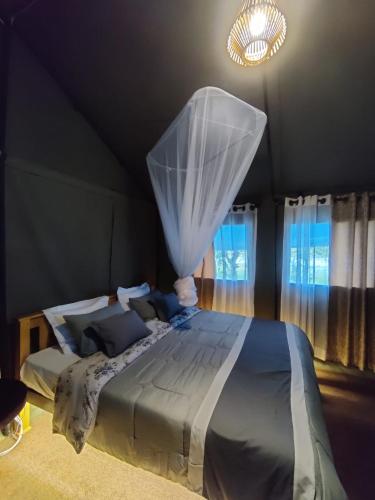 a bedroom with a bed with a mosquito net at Harmony Haven, Udawalawe, Sri Lanka in Udawalawe