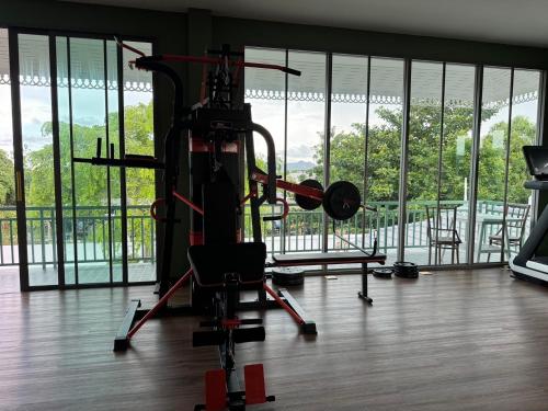 a room with a gym with large windows at Pailin Pool Villa,HuaHin in Hua Hin