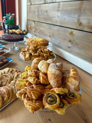 a table topped with plates of pastries and pies at Villa Camporosso in Colà di Lazise