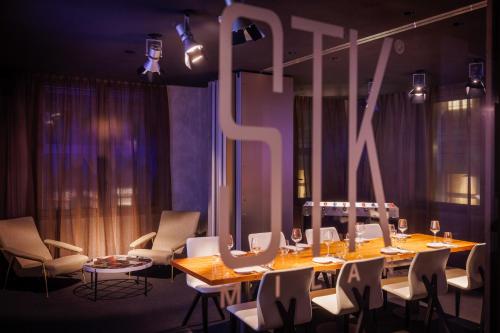 a dining room with a long table and chairs at ME Milan Il Duca in Milan