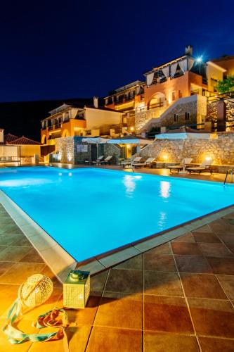 a large swimming pool in front of a building at Apelon Tiritas Villas in Leonidion