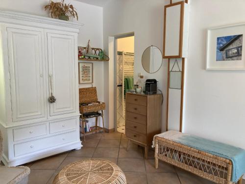 a living room with a dresser and a bedroom at Douceur des Pins in Saint-Trojan-les-Bains
