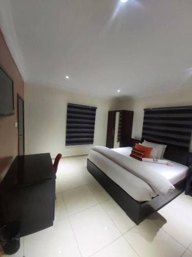 a bedroom with a large bed and a couch at TRENDY INN HOTEL in Lagos
