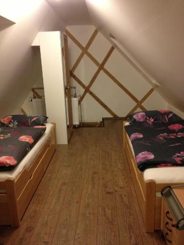 a room with two beds in a attic at Old Town Guesthouse Erlangen in Erlangen