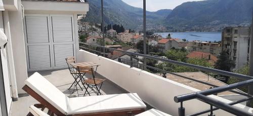a balcony with chairs and a view of a city at Apartments Dakovic in Kotor