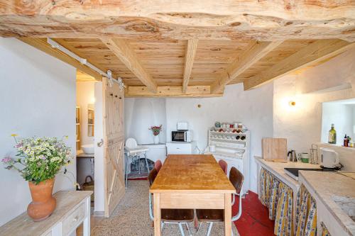 a kitchen and dining room with a wooden table at NEW! Windmill in the midst of nature in Mafra