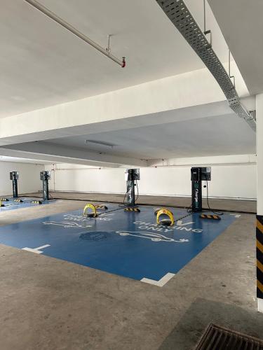 a parking lot with a blue floor in a parking garage at Holiday Inn Sepang - Airport in Sepang