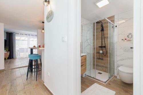 a bathroom with a shower and a toilet and a sink at Apartmans and studios Ana in Trogir