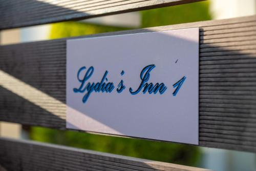 a sign on the side of a wooden bench at Lydia's Inn 1 - Private pool, near Xylokastro in Melíssion