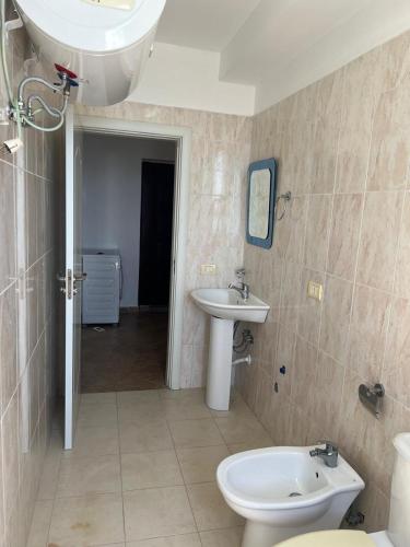 Apartamente ne Shengjin في شينجين: حمام مع حوض ومرحاض
