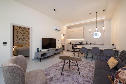 a living room with a couch and a dining room at The Bridge City Luxury Apartments in Zadar