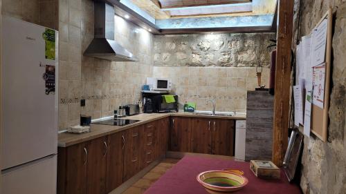 a kitchen with a sink and a refrigerator at Casa Rural El Molinar in Albacete