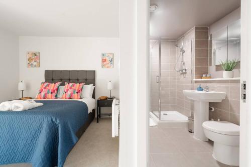 a bedroom with a bed and a bathroom with a sink at Chavasse Apartments, 1 Bed Studio, Parking - Pass the Keys in Liverpool