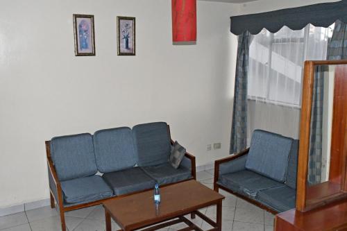 a living room with a couch and a table at YWCA Parkview Suites in Nairobi