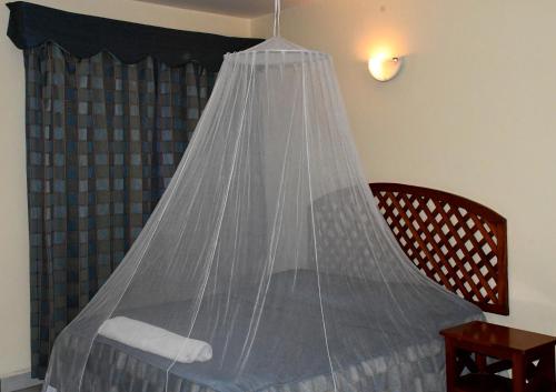 a bed with a net on top of it at YWCA Parkview Suites in Nairobi
