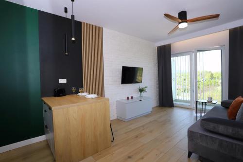 a living room with a couch and a table at Apartament Zielone Podwale in Wałbrzych