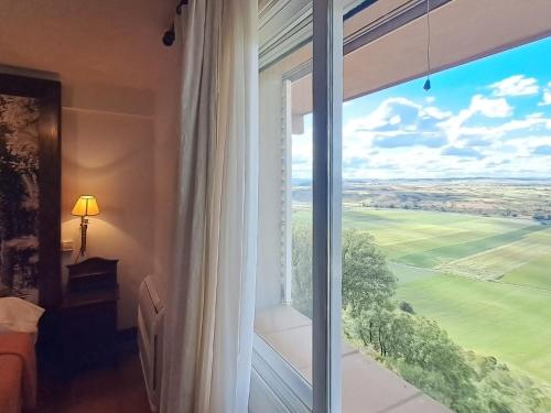 a room with a large window with a view at Hotel Rural & Spa Las Nubes in Albalate de Zorita
